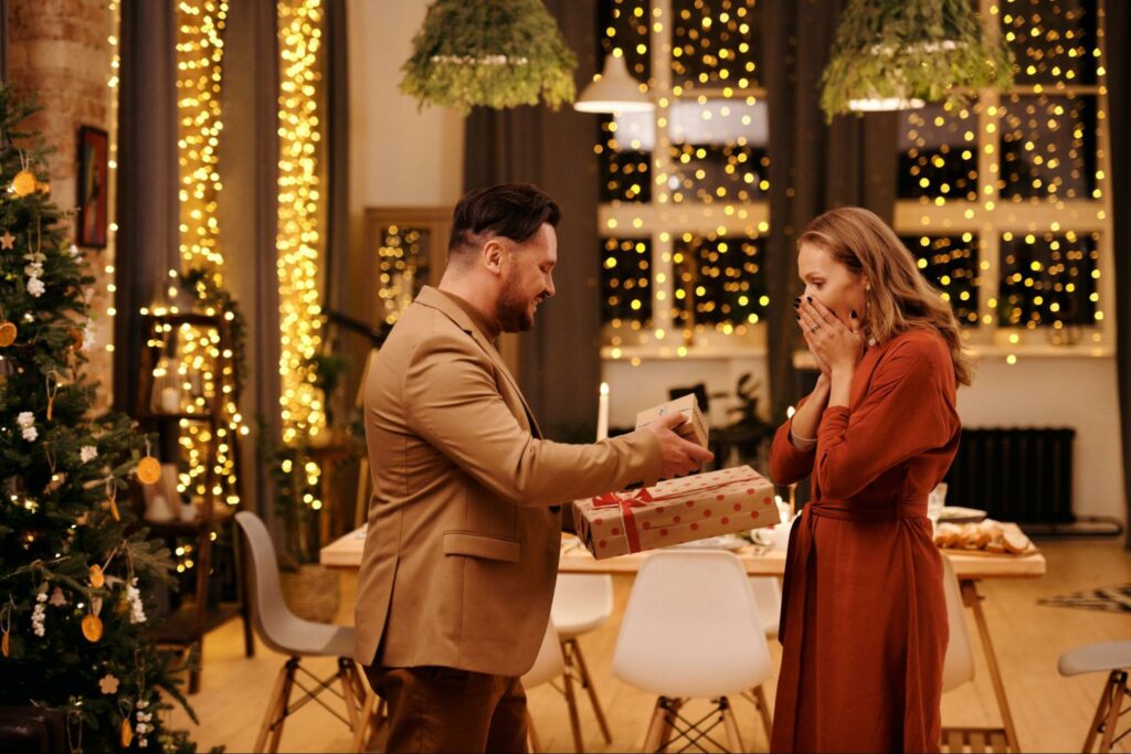 Man giving gift to woman