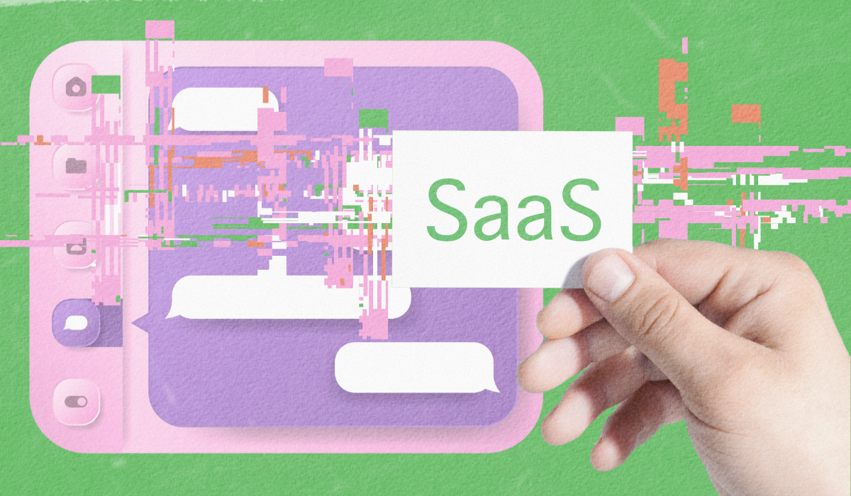 A hand holding a card with the word "SaaS" against a stylized green background with digital interface elements, representing the human element in software-as-a-service marketing.