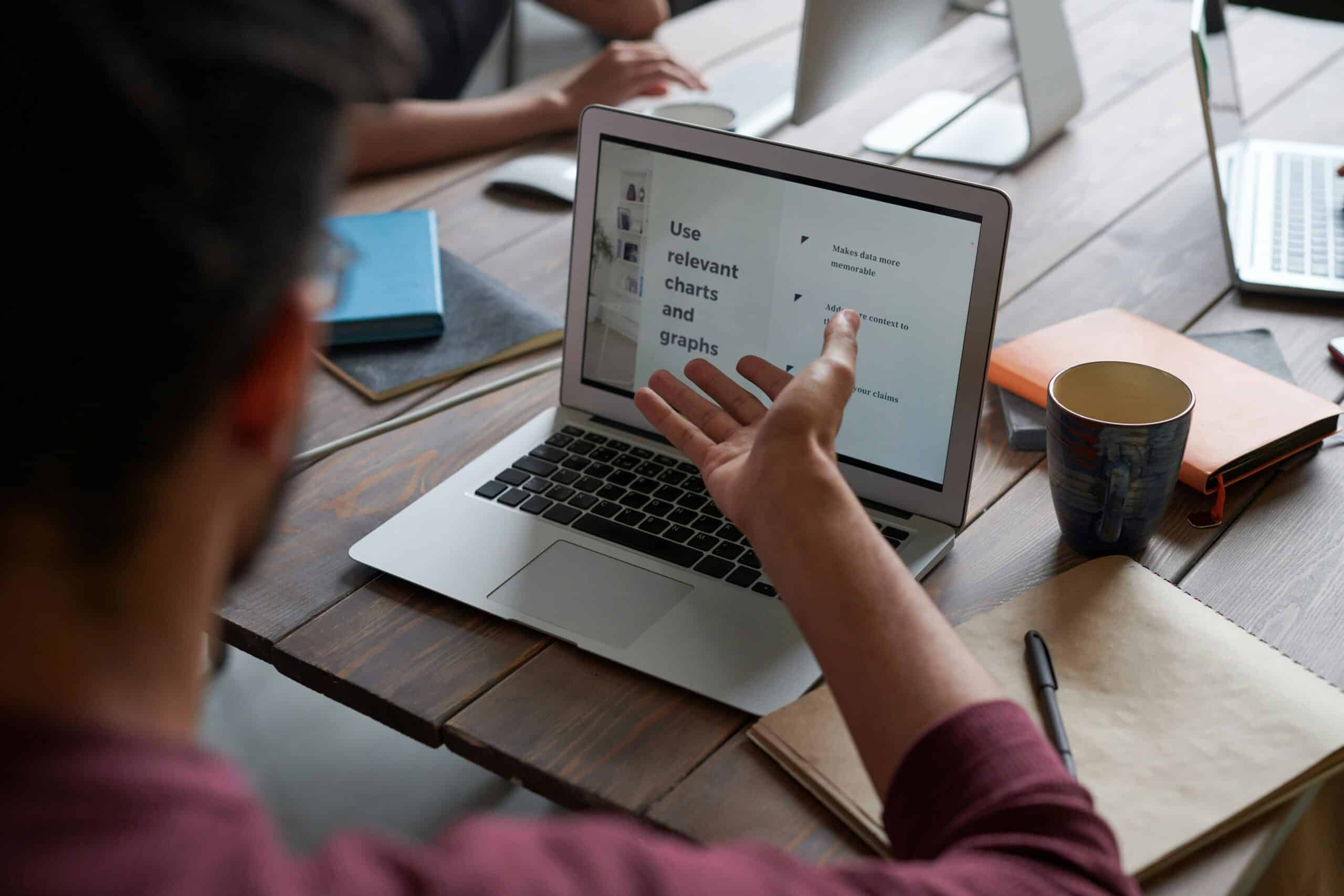 A person presenting on their laptop