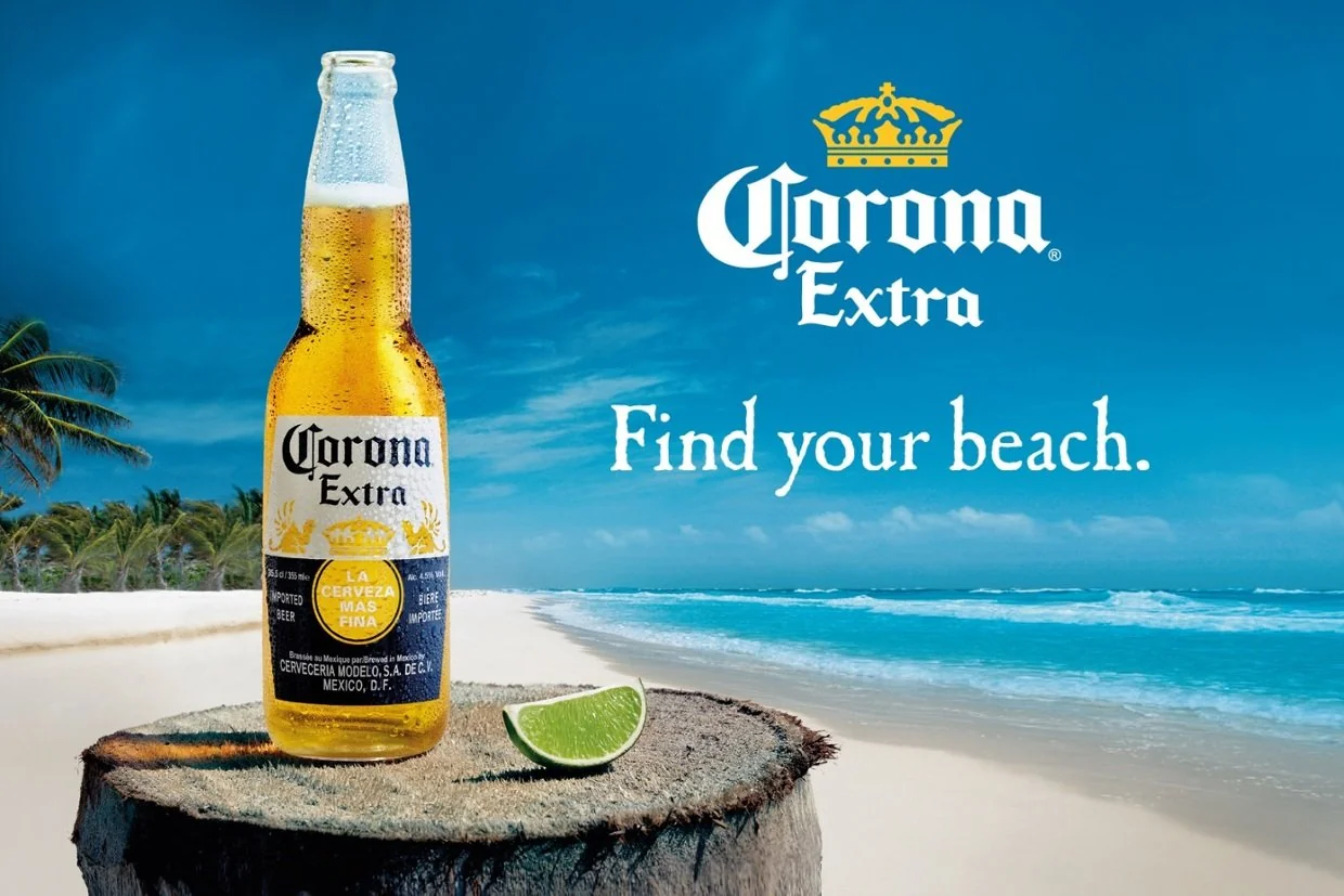 Corona Extra bottle on a beach with the slogan 'Find your beach,' evoking relaxation and escape through one of the most iconic lifestyle-driven famous slogans.