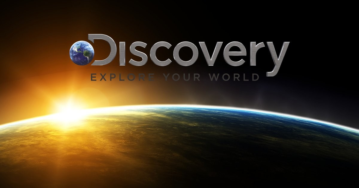 Discovery logo over a sunrise view of Earth from space, with the slogan 'Explore Your World,' symbolizing curiosity, learning, and one of the most aspirational famous slogans in media.