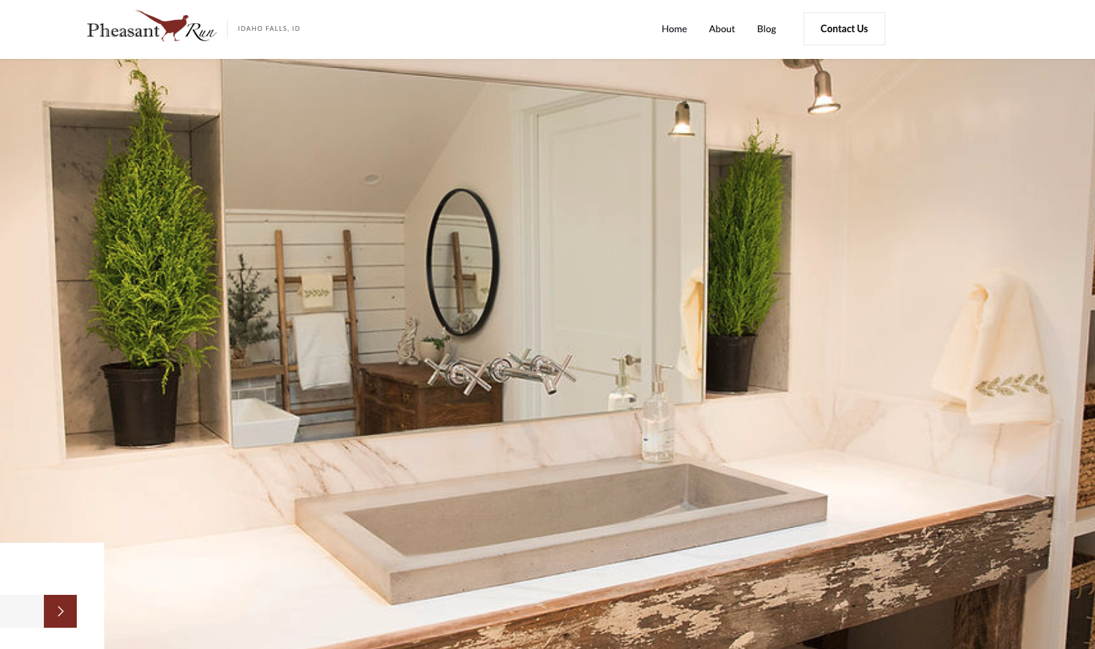 Screenshot of Pheasant Run blog showing a rustic bathroom with a stone sink and wood-framed mirror, focused on farmhouse-style interior design.