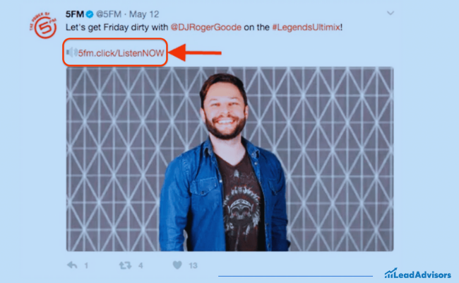 This image shows a tweet from the verified Twitter account 5FM promoting a DJ segment featuring DJ Roger Goode using the hashtag #LegendsUltimix. The tweet includes a branded vanity URL, “5fm.click/ListenNOW,” highlighted with a red arrow and border to draw attention to the link. Below the tweet is a photo of a smiling man in a denim jacket standing against a patterned backdrop.