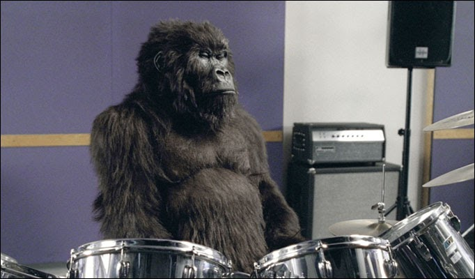 Man in a gorilla suit playing drums in Cadbury’s surreal and iconic ad featuring Phil Collins’ “In the Air Tonight.”