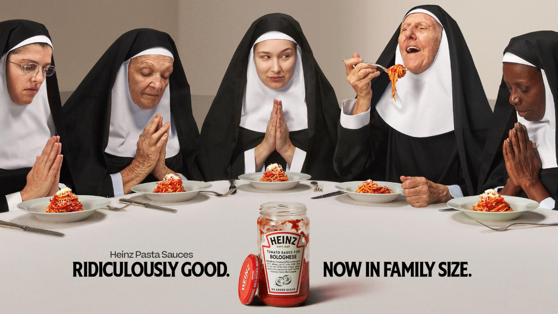 A humorous ad featuring nuns eating pasta with a jar of Heinz pasta sauce, showcasing lifestyle product placement in everyday food scenes.