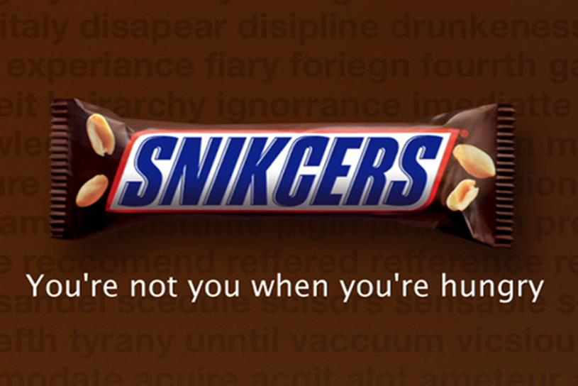 Snickers bar with the campaign slogan “You’re not you when you’re hungry” on a bold brown background.