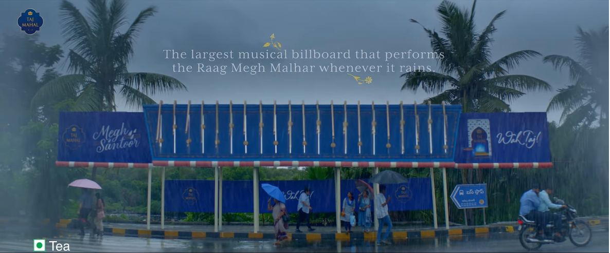 Billboard at a rainy bus stop designed as a musical instrument that plays the Raag Megh Malhar when it rains.
