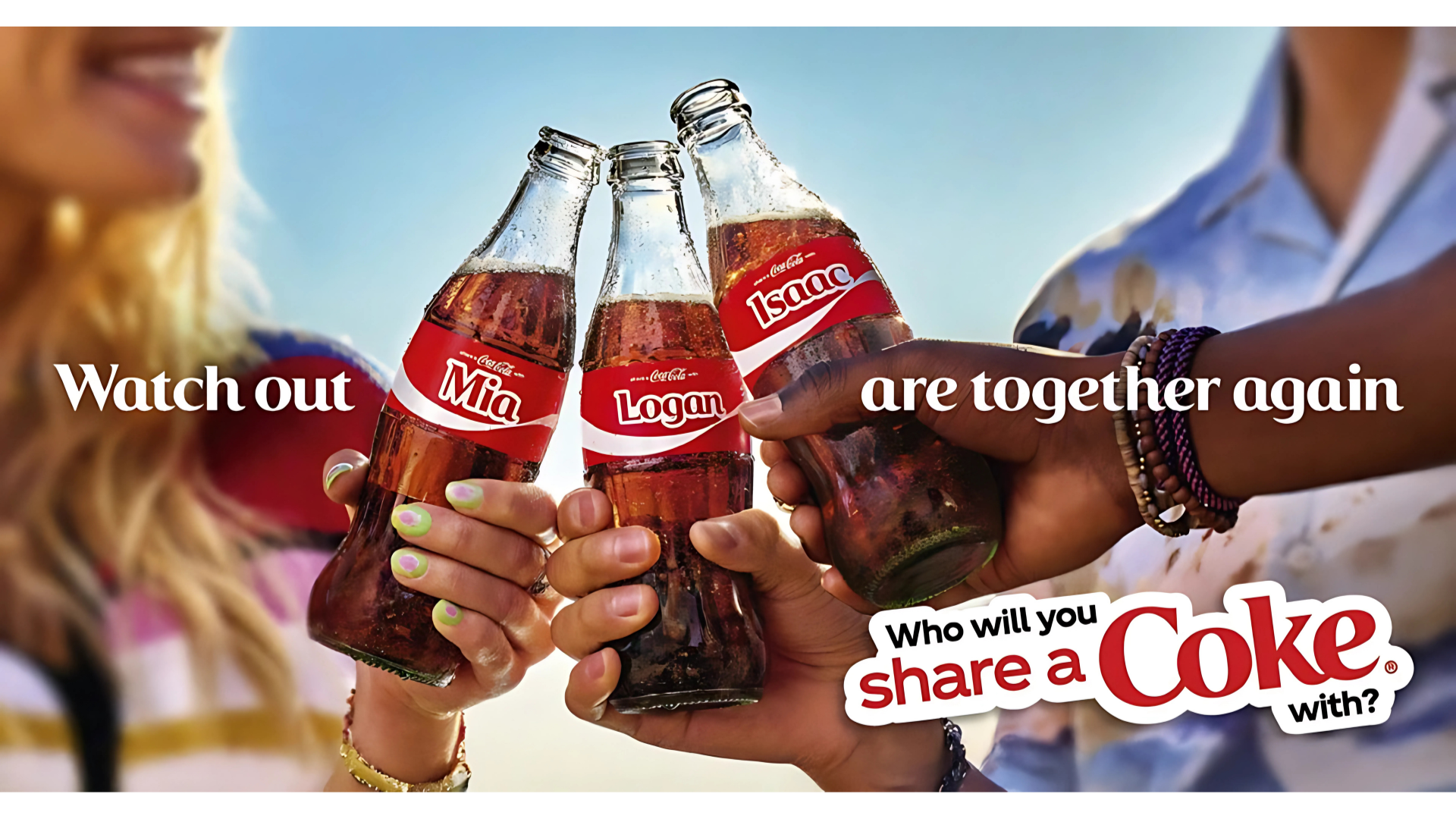 Three friends clink personalized Coca-Cola bottles labeled Mia, Logan, and Isaac. The ad promotes the “Share a Coke” campaign with the tagline “Who will you share a Coke with?”