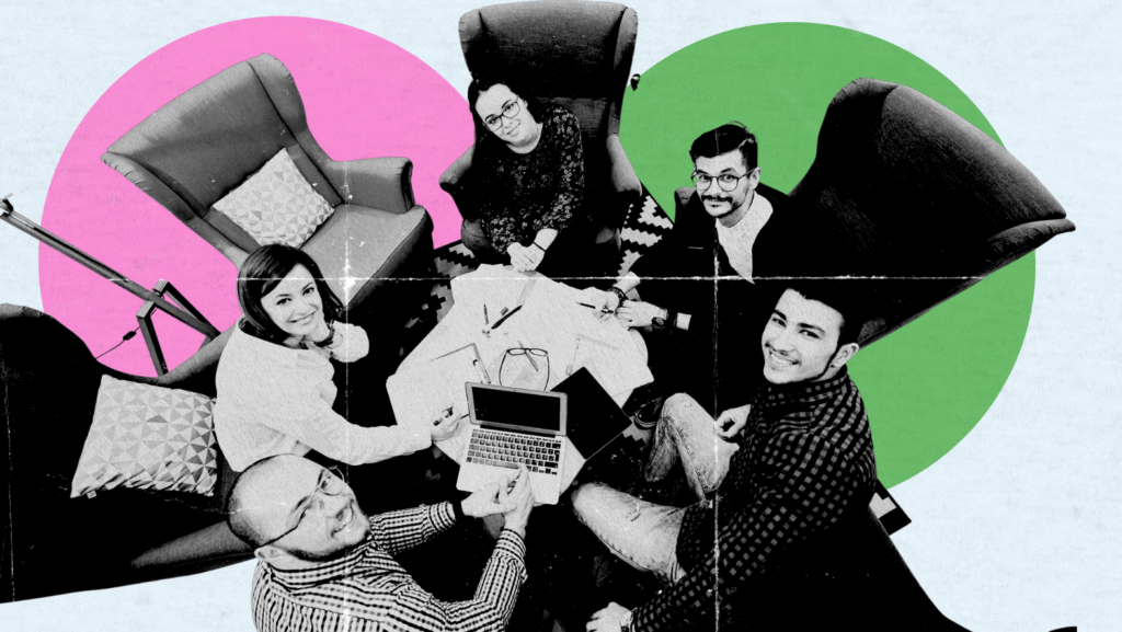 A diverse startup team sitting in a circle with laptops and notes, collaborating in a modern workspace.