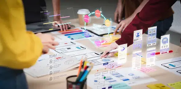 Team working on UX design strategy with wireframes, sticky notes, and holographic digital interface elements projected above the table.