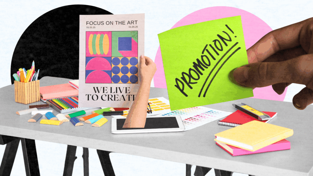 A hand holds a green sticky note that says PROMOTION! over a desk scattered with art supplies, notebooks, colored pencils, and a poster reading FOCUS ON THE ART. WE LIVE TO CREATE—perfect for creative brand promotion.