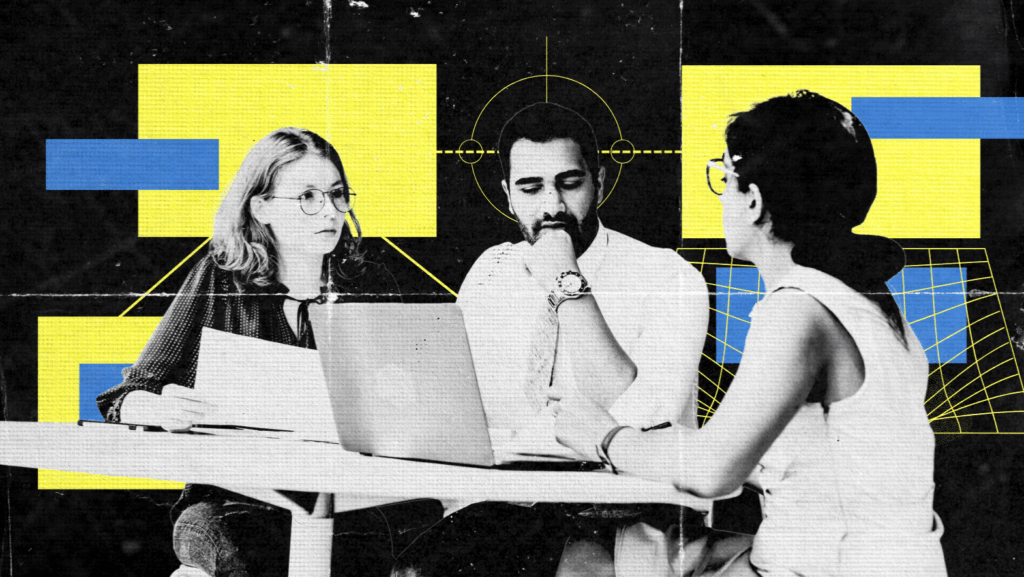 Three people sit at a table having an EEAT-focused discussion with papers and a laptop, overlaid with abstract yellow and blue geometric shapes on a black background.