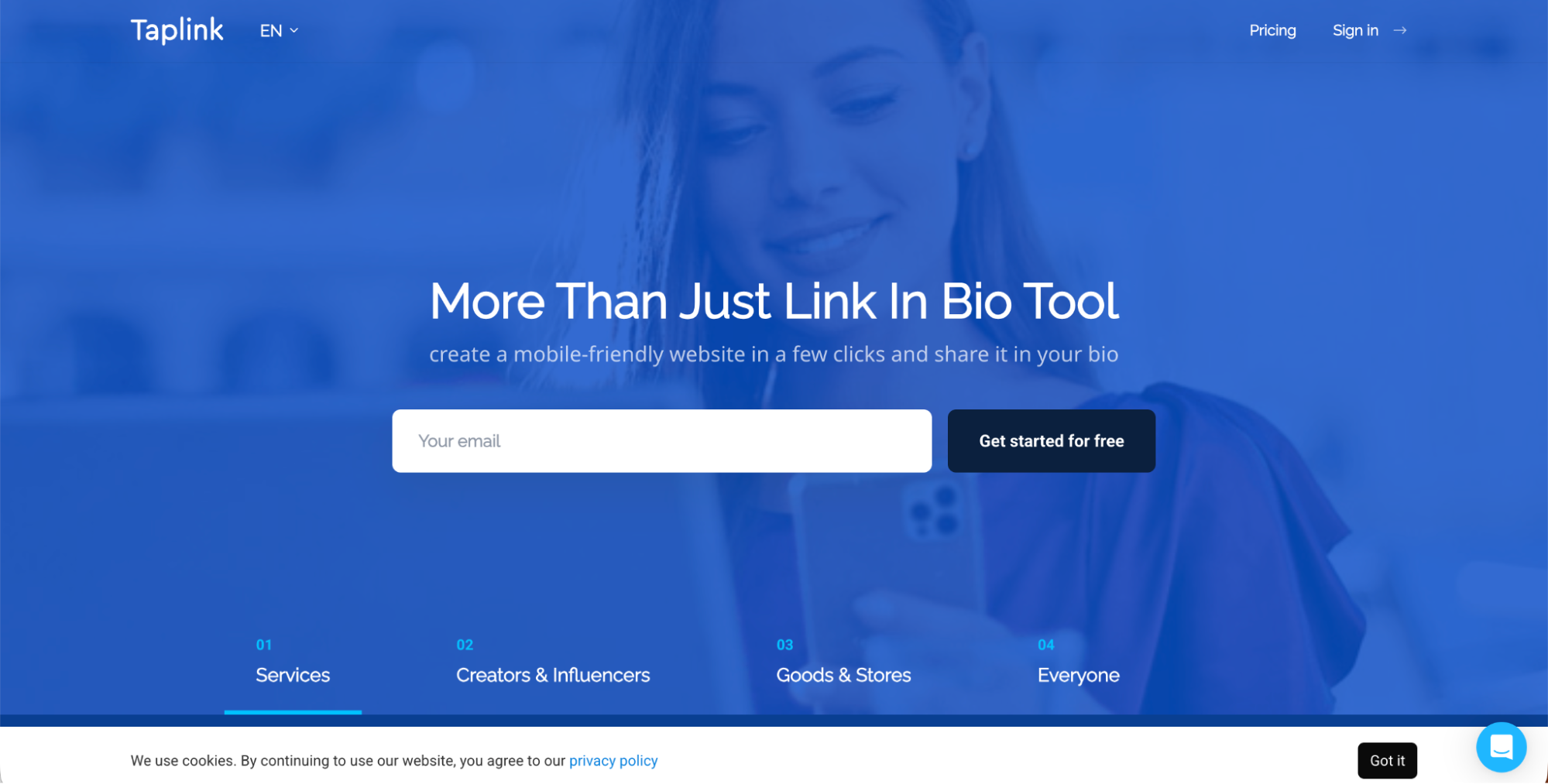 A woman holding a phone smiles in the background of Taplink’s homepage, which features a signup form for a link-in-bio tool—one of the top Linktree alternatives—with a navigation menu for services, creators, stores, and account options.