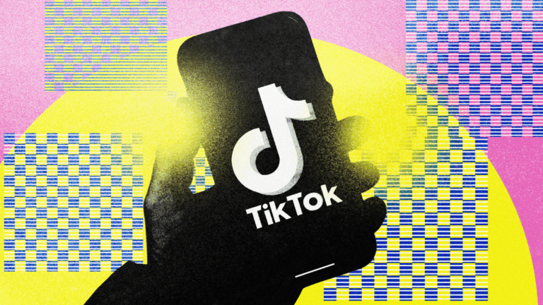 Hand holding a smartphone with the TikTok logo on a colorful background.