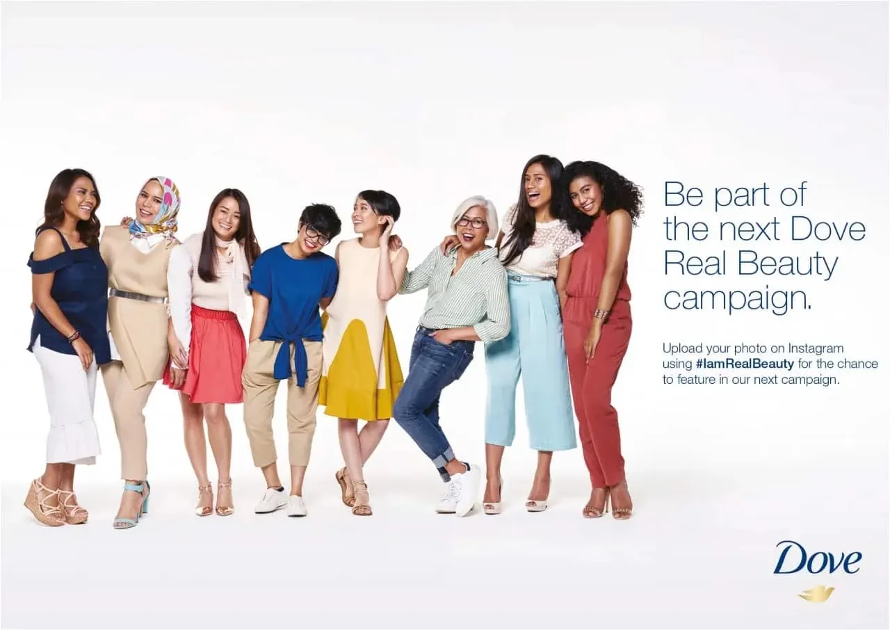 A diverse group of women stand together smiling beside text inviting people to join the next Dove Real Beauty campaign.