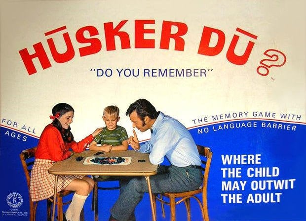 A vintage Hüsker Dü advertisement shows a family playing the memory game, highlighting its accessibility and tagline “Where the child may outwit the adult.