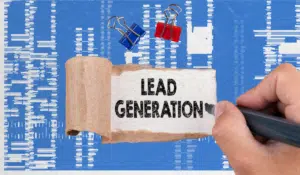 Lead generation concept image with the words ‘Lead Generation’ on paper over an analytics-style background