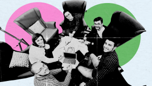A diverse startup team sitting in a circle with laptops and notes, collaborating in a modern workspace.